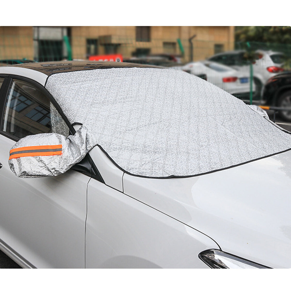 Silver magnetic windscreen frost cover fitted over a car windscreen, with a mirror cover on the wing mirror (supplier photo)